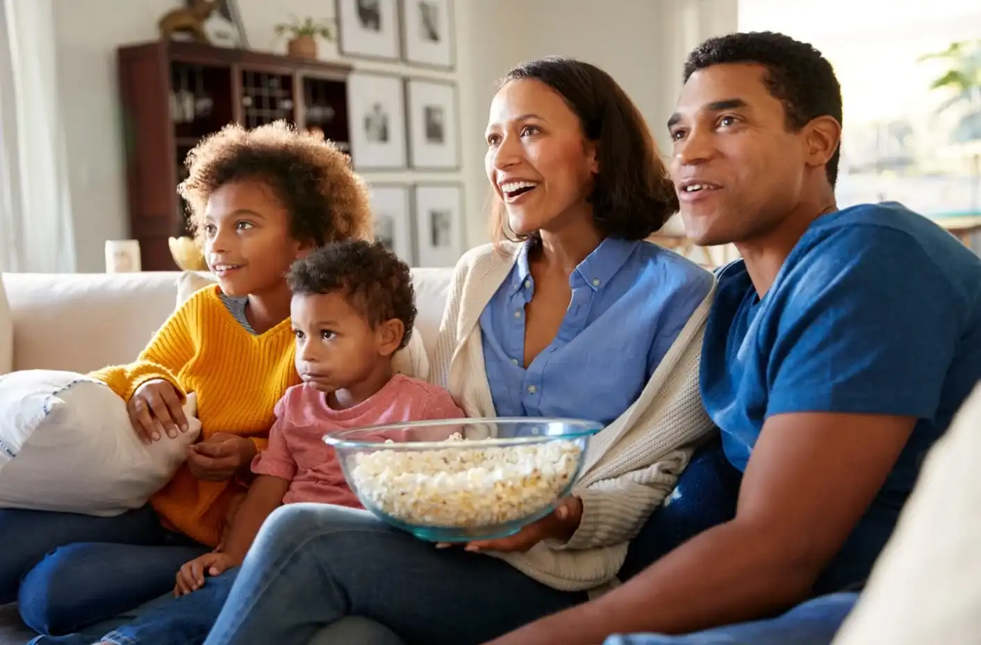family on couch watching television